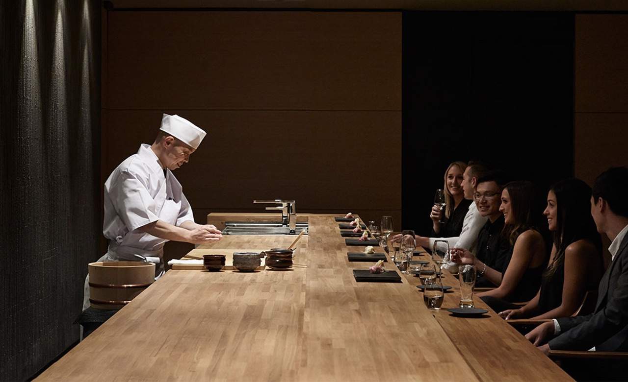 a small group of people enjoying the omakase experience at Minamishima - seafood sushi omakase restaurant in Richmond, Melbourne