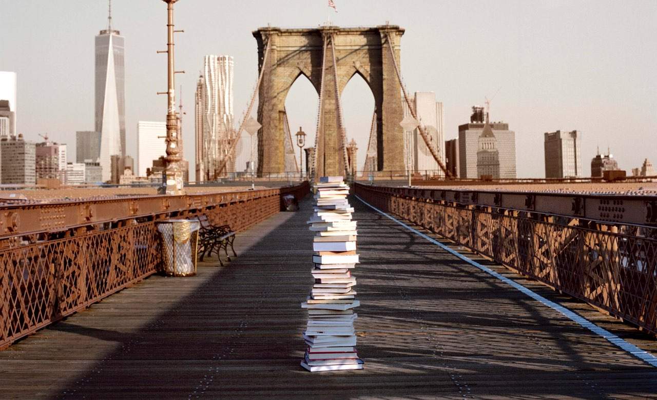 This New York Artist Leaves Piles of His Books in the Busiest Spots Around the City