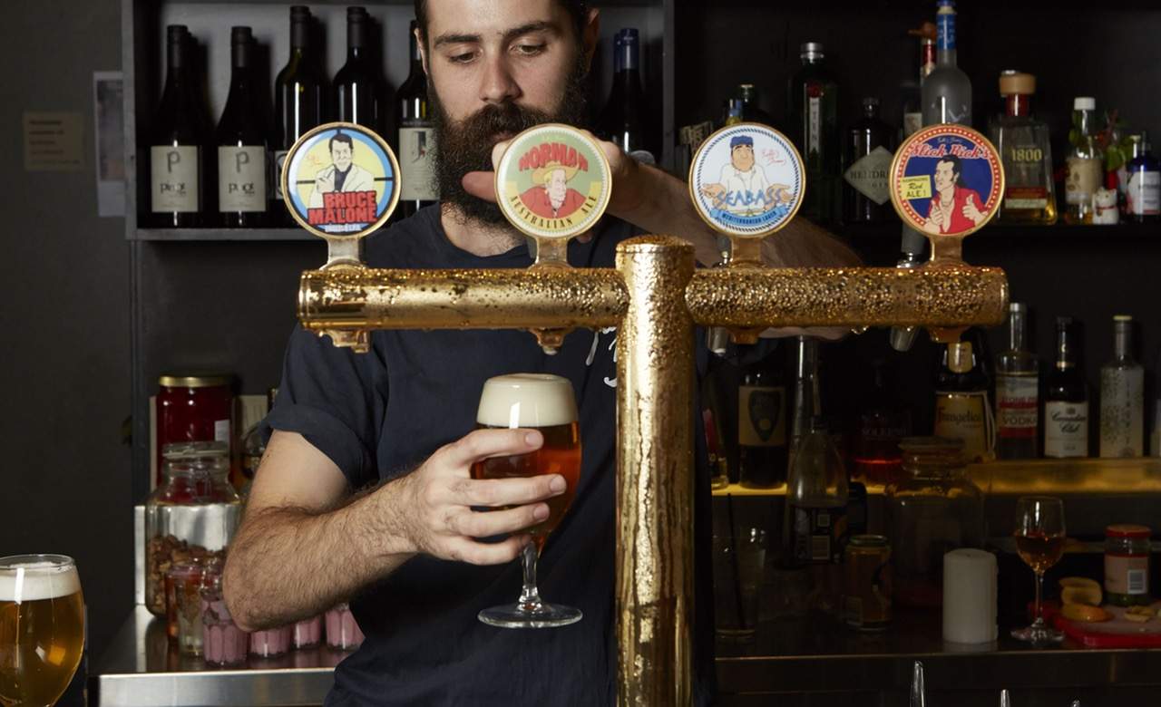 bartender pouring beer at Yulli's - vegetarian restaurant in Sydney