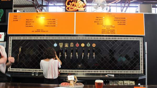 Bartender pouring beers at The Grifter Brewing Co in Sydney.