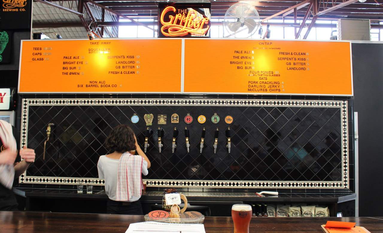 Bartender pouring beers at The Grifter Brewing Co in Sydney.