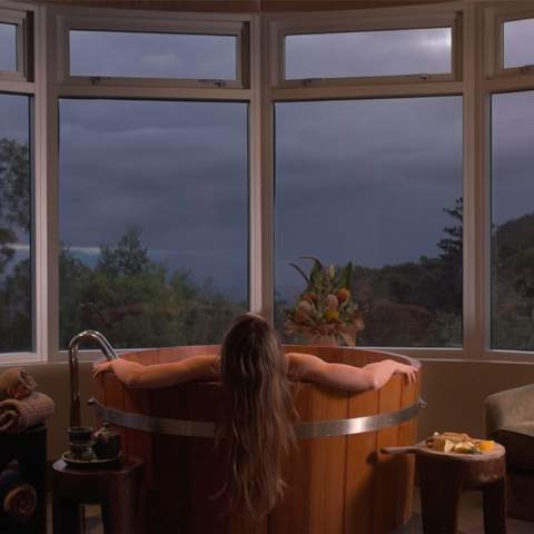 Someone soaking in a tub at O'Reilly's Lost World Day Spa - one of the best day spas in Brisbane.