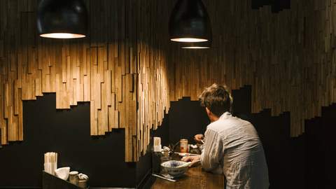 A person eating ramen at Taro's Ramen - one of the best Japanese restaurants in Brisbane.