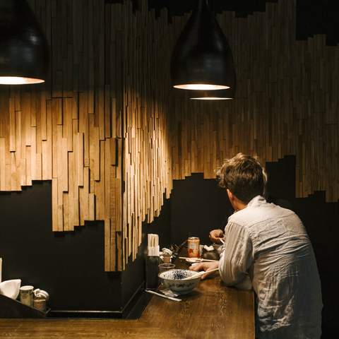 A person eating ramen at Taro's Ramen - one of the best Japanese restaurants in Brisbane.