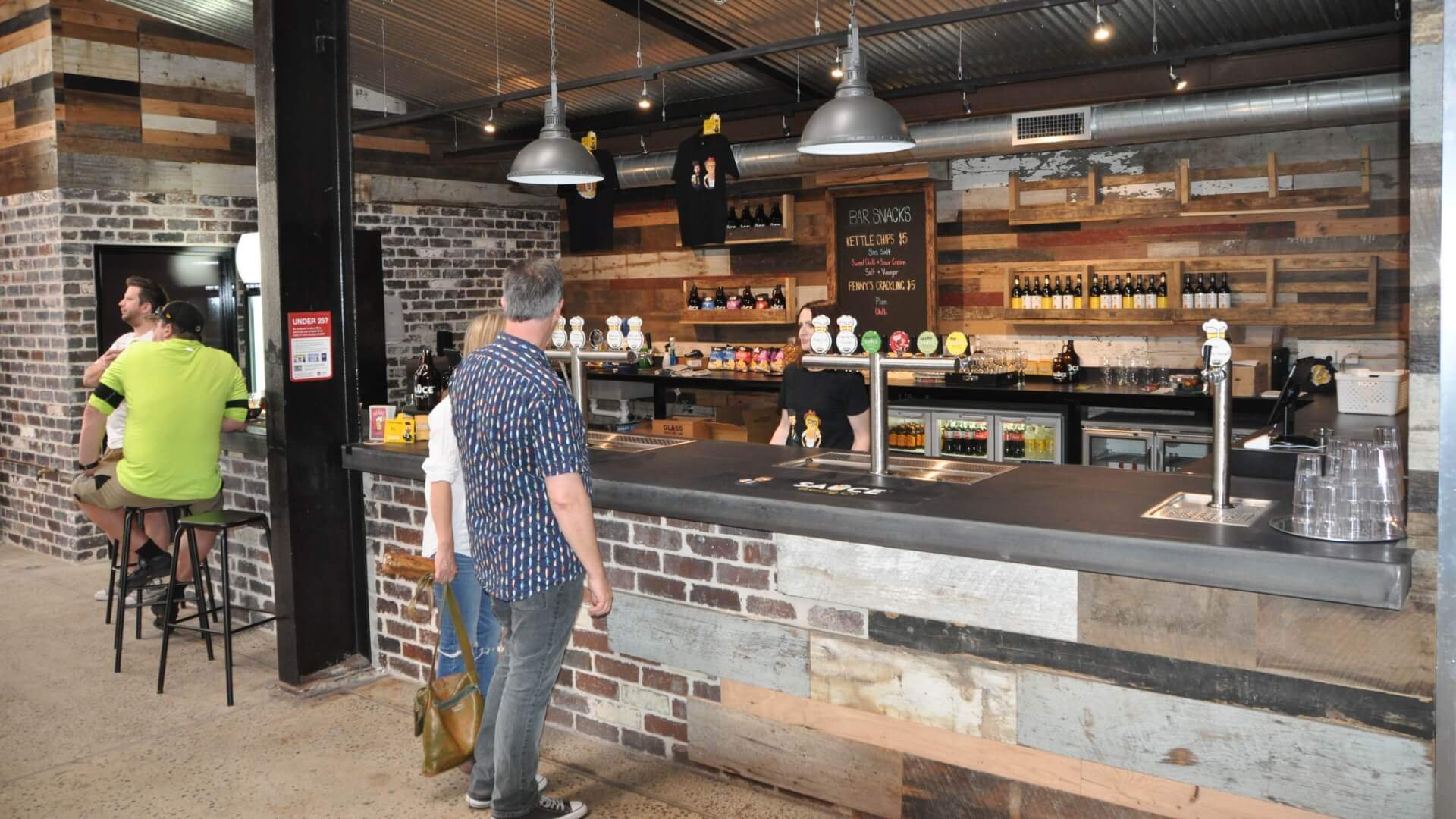 People ordering at the bar at Sauce Brewing Co in Marrickville, Sydney - one of the best sydney brewery bars