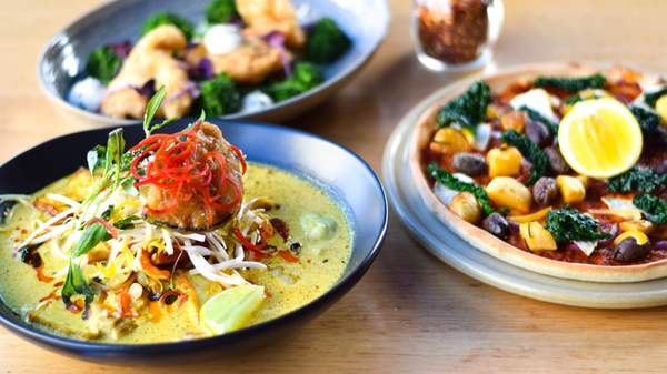 A table with vegan curry, pizza and salad at Vegie Bar on Fitzroy's Brunswick Street
