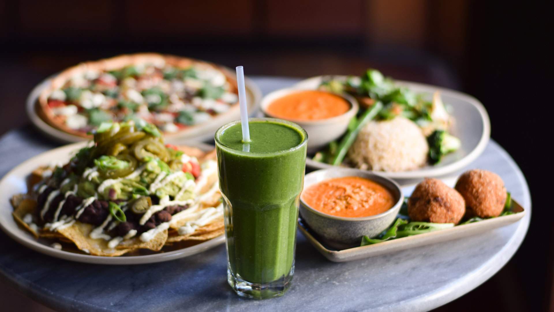 a vegan smoothie with vegan nachos, pizza and curry at Vegie Bar on Brunswick Street in Fitzroy