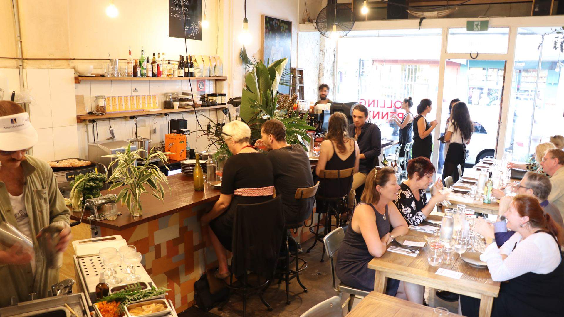 People eating at tables and at the bar at rolling penny, - one of the best cafes in Sydney