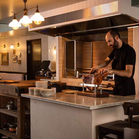 chef shaving a leg of ham at Bistecca - one of the best steak restaurants in sydney