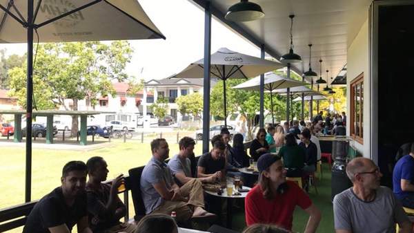 big group of people drinking outside at The Pineapple Hotel - one of the best sports bars in Brisbane