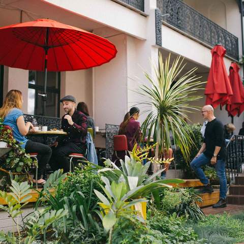 People dining outside under umbrellas at Circa Espresso - - one of the best cafes in Sydney