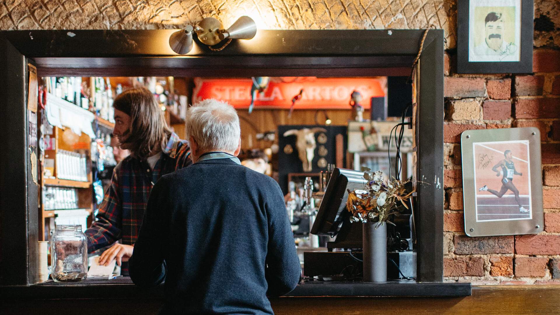 Someone ordering a drink at The Standard Hotel in Fitzroy - one of the best pubs in Melbourne.