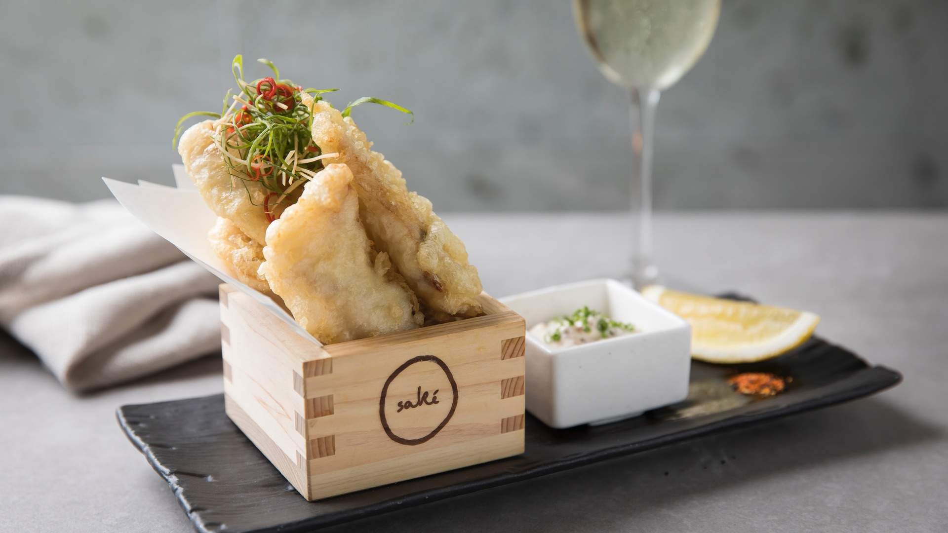 battered fish and a glass of wine at Sake Restaurant and Bar Manly