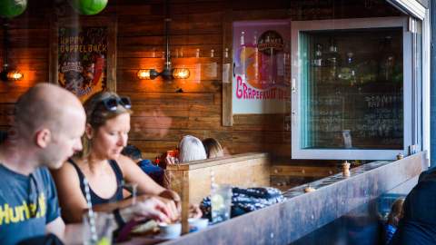 person pouring beers at 4 Pines Brewpub - Sydney brewery - manly