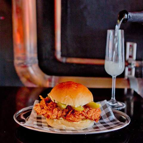 chicken burger and a glass of champagne at Butter - home to some of the best burgers in sydney