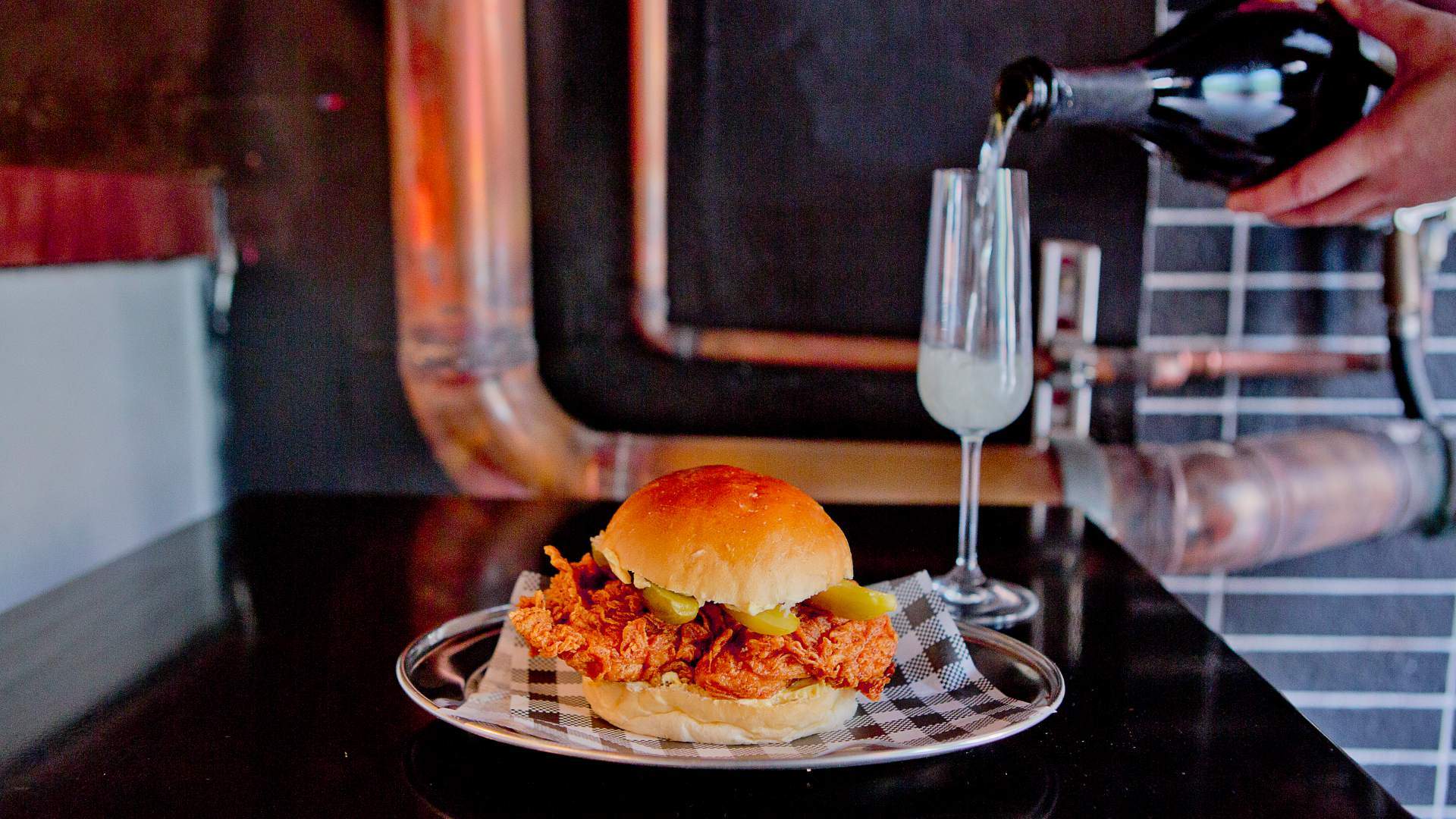 chicken burger and a glass of champagne at Butter - home to some of the best burgers in sydney