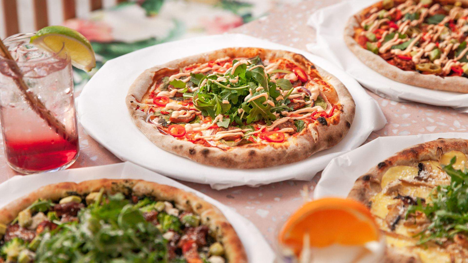 vegan pizzas and cocktails on a table at Sydney's Eden Bondi restaurant