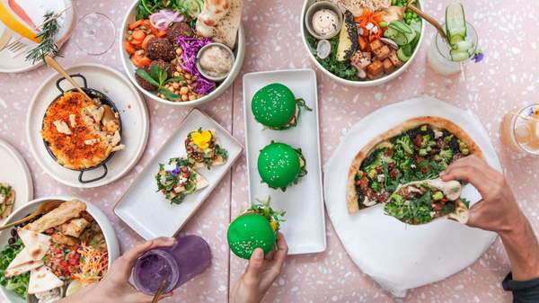 a selection of vegan eats at Sydney's Eden Bondi. Vegan pizza, burgers and tacos