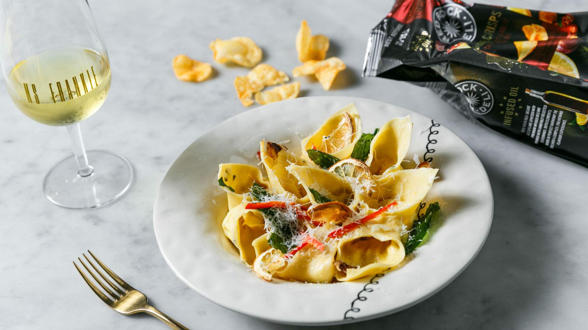 a bowl of pasta and white wine at Ms Frankie in Melbourne