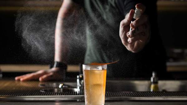 Bartender spraying cocktail