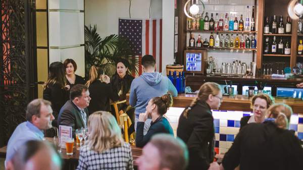 a crowd of people around the bar at Buffalo Bar