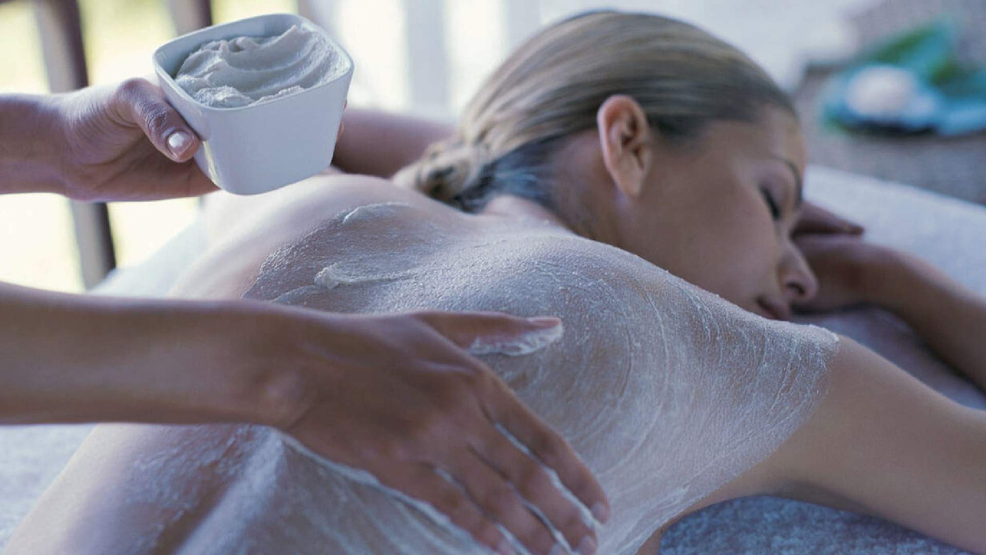 A woman receiving a body scrub treatment at NATSKIN, NORTH RINGWOOD - one of the best spas in Melbourne