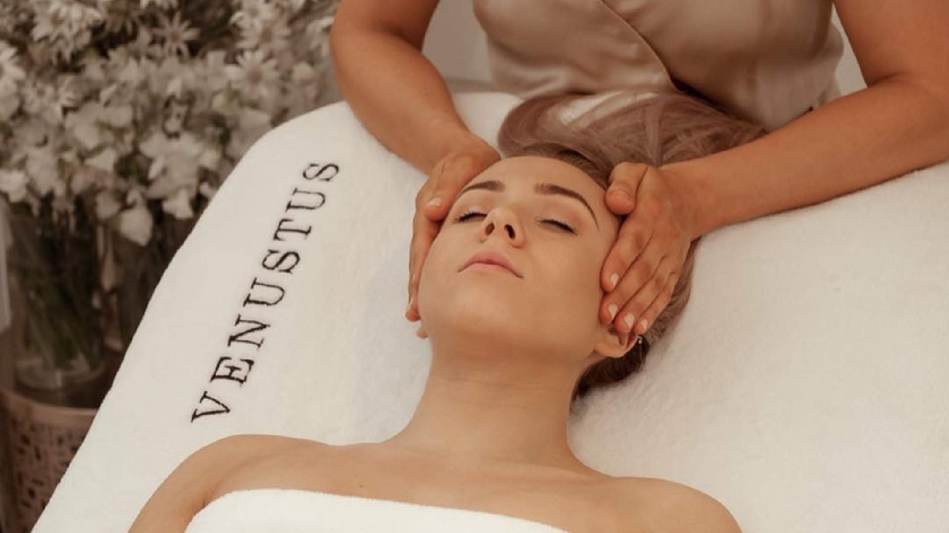 A woman receiving a head massage at venustus beauty - one of the best day spa experiences in sydney