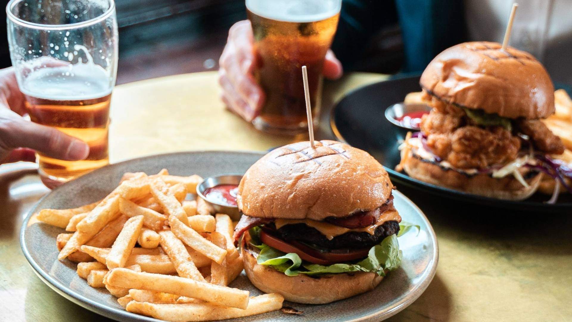 burgers and beers on a table
