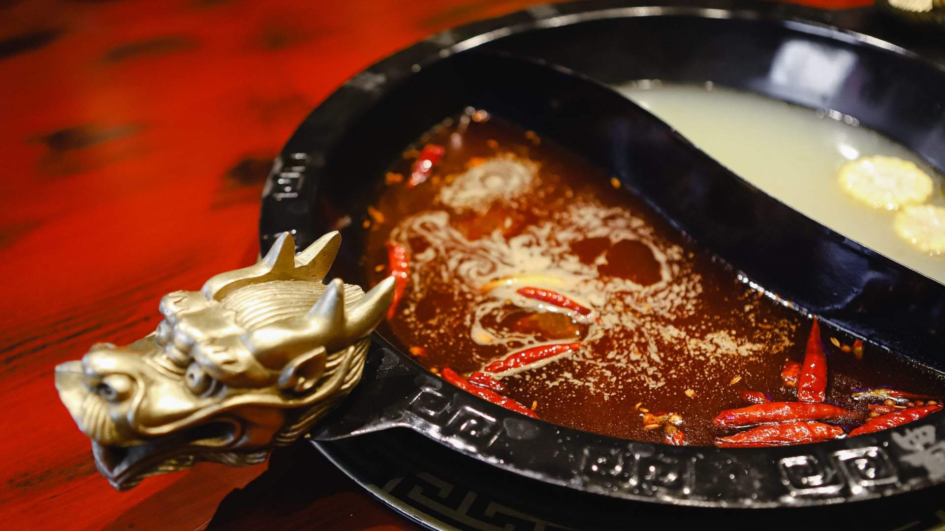 two kinds of broth in a dragon hot pot at Panda Hot Pot - one of the best hot pots in Melbourne