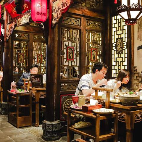 a group of people eating at Panda Hot Pot - one of the best hot pot spots in Melbourne