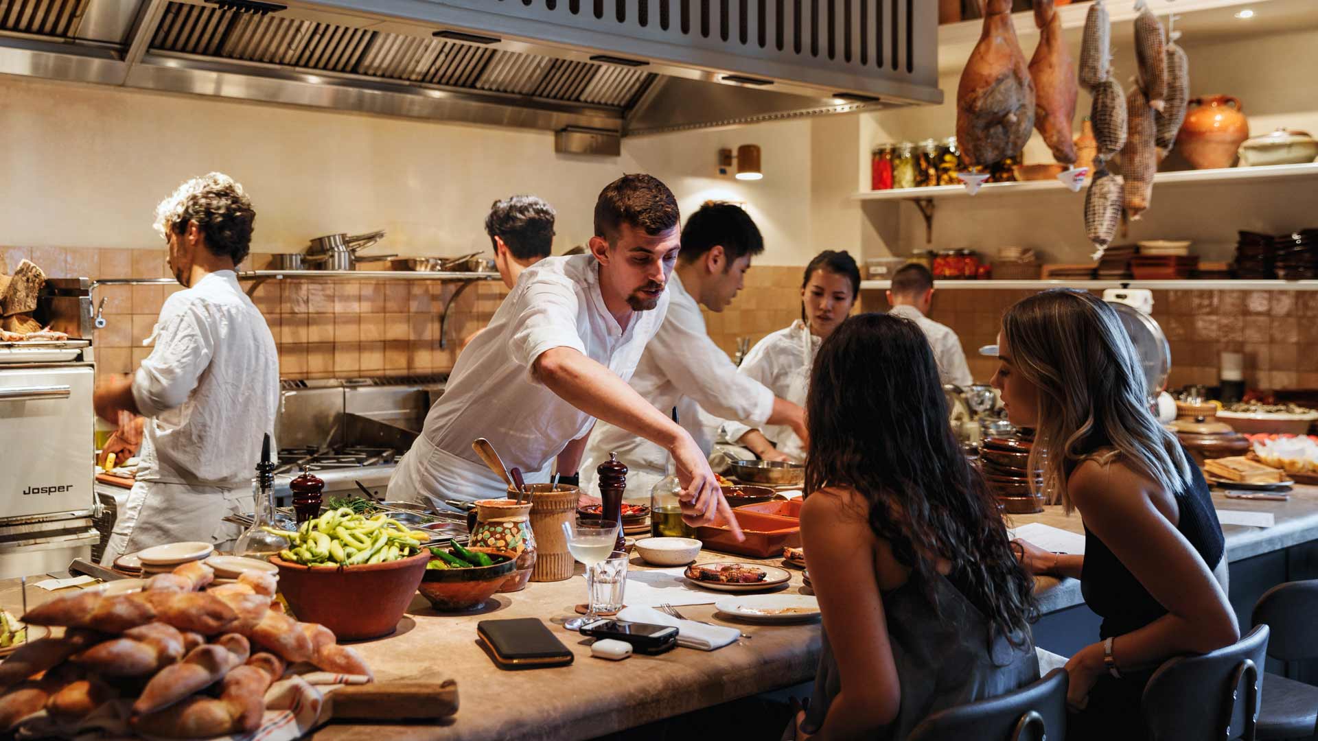 a chef serving food at Una MAs - one of the best bars in Sydney