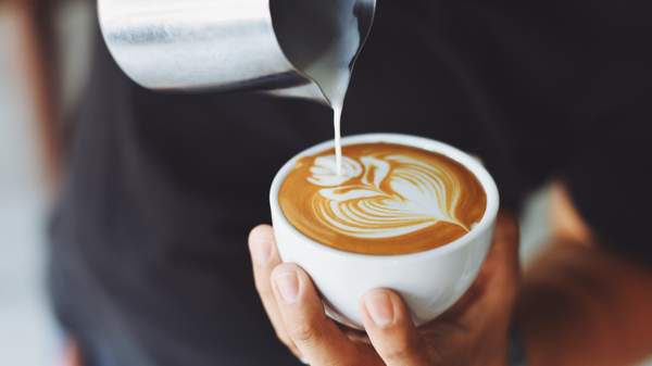 milk pouring into cappuccino