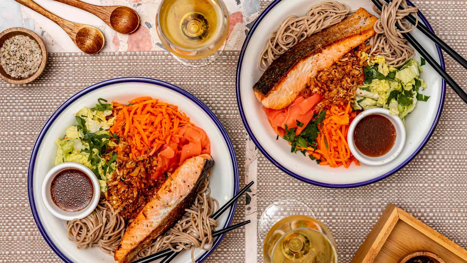 Two plates of crispy salmon with soba noodles