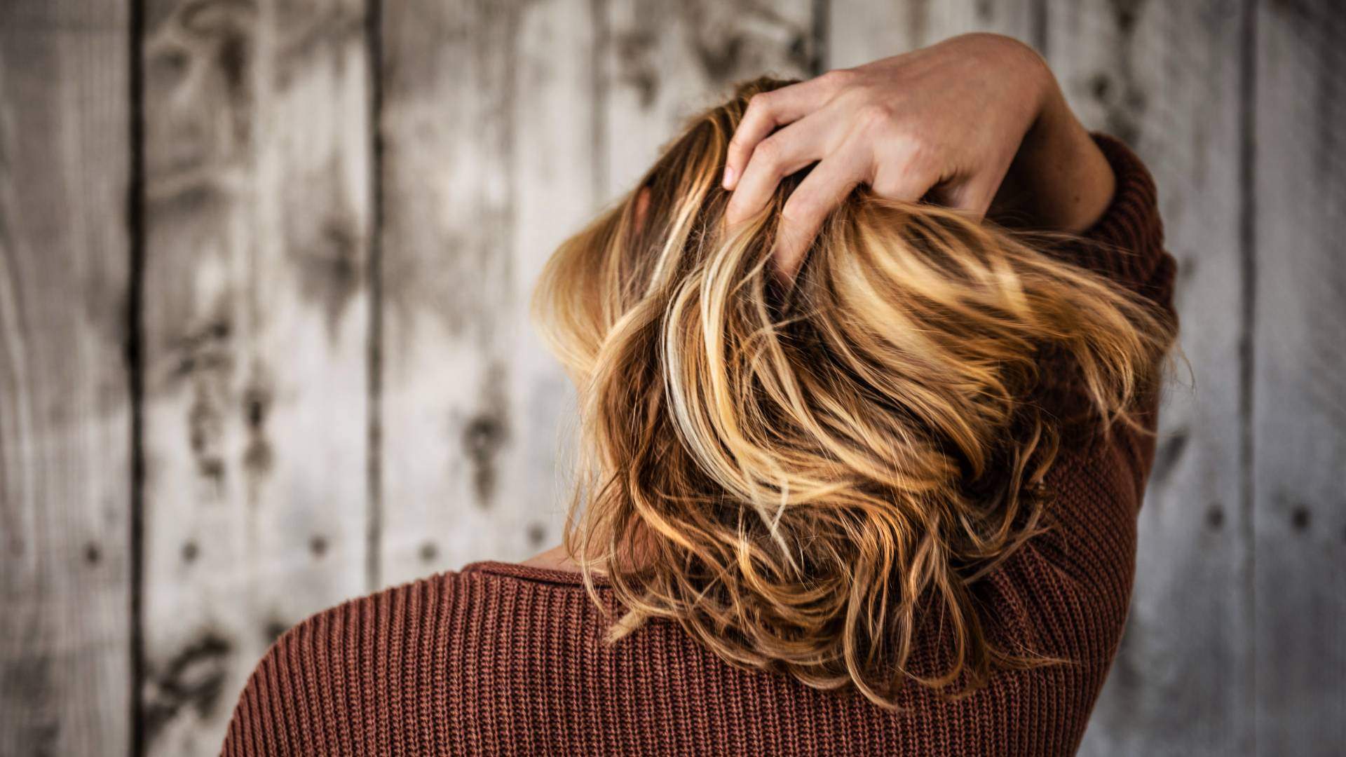 Woman holding her hair with her back to the camera