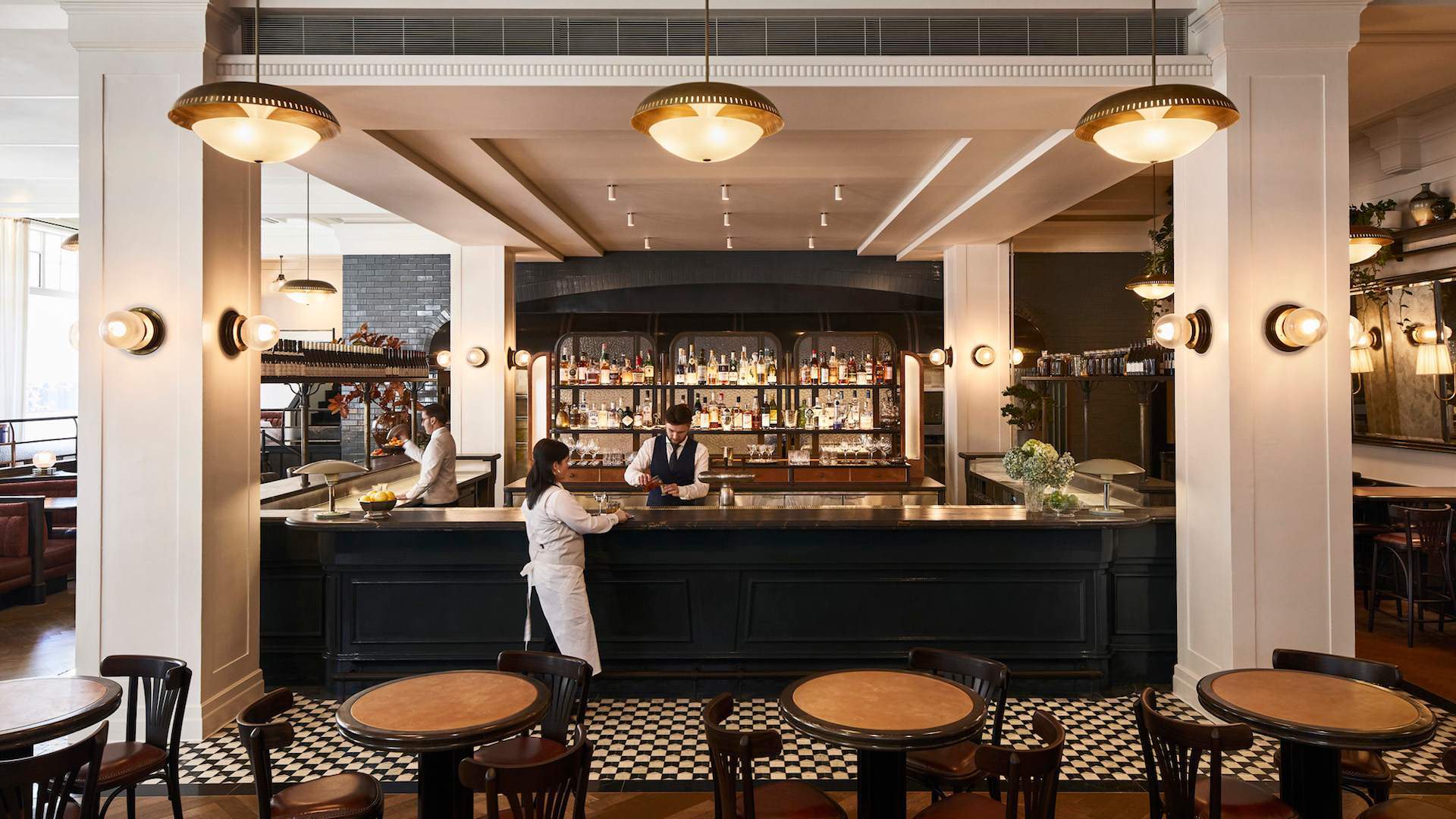 the bar with bartenders walking past at Gimlet at Cavendish house - one of the best late-night eats spots in Melbourne