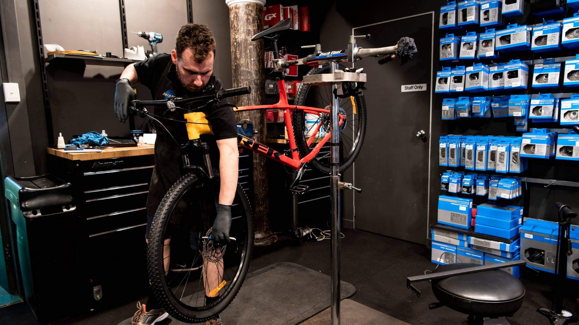 Staff servicing a bike at Clarence St Cyclery