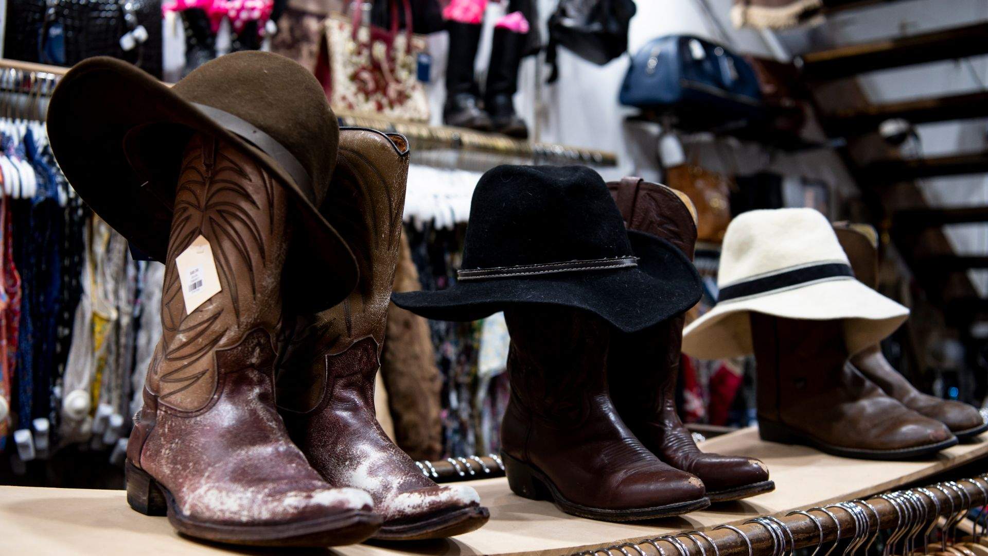Cowboy boots and hats at a vintage store