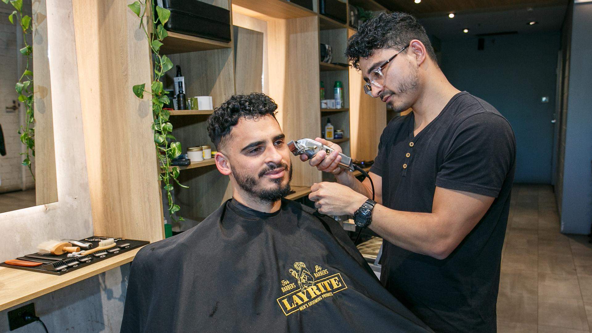 Barber cutting a customer's hair