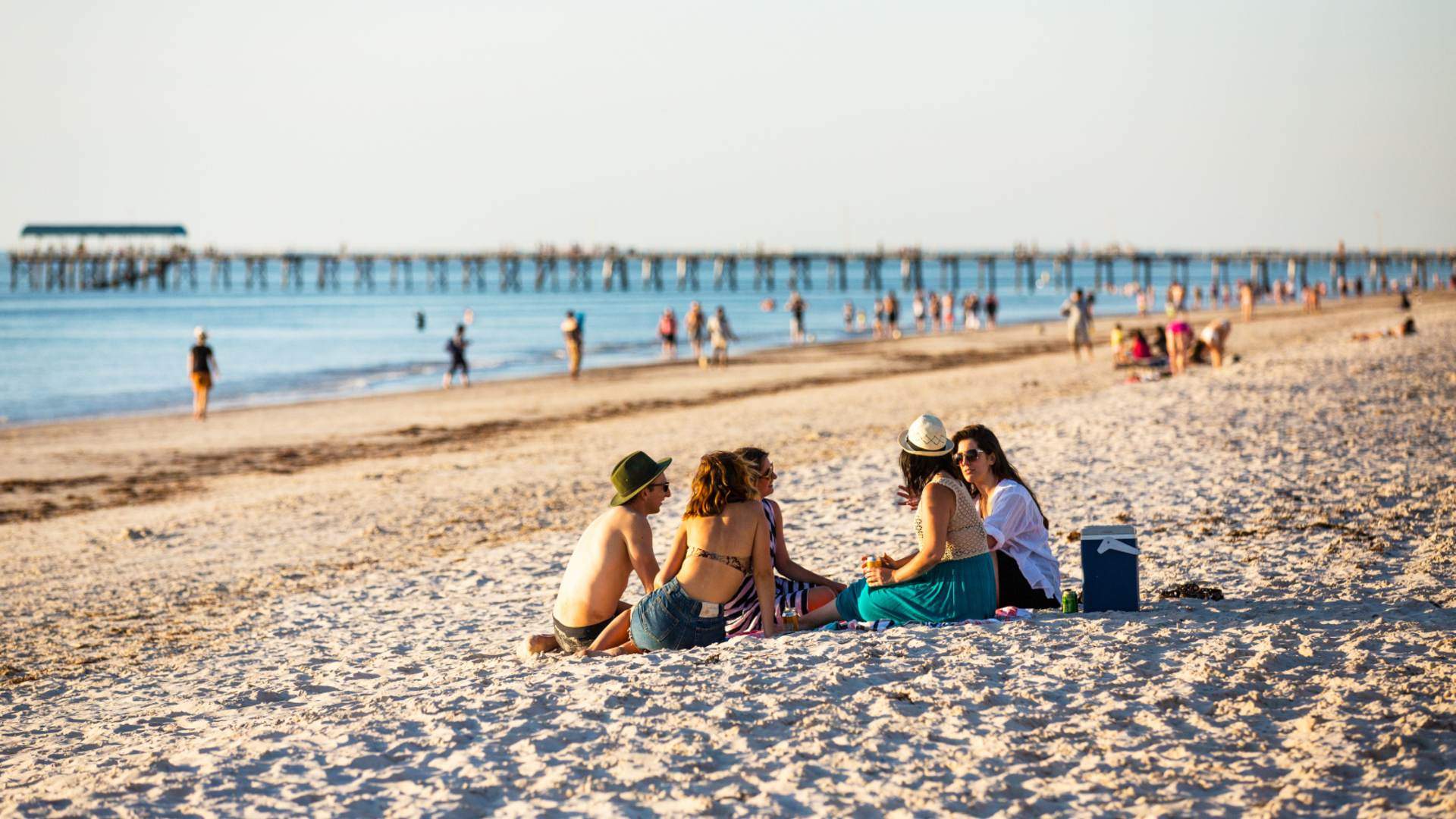 Group of friends sitting on Henley Beach, South Australia