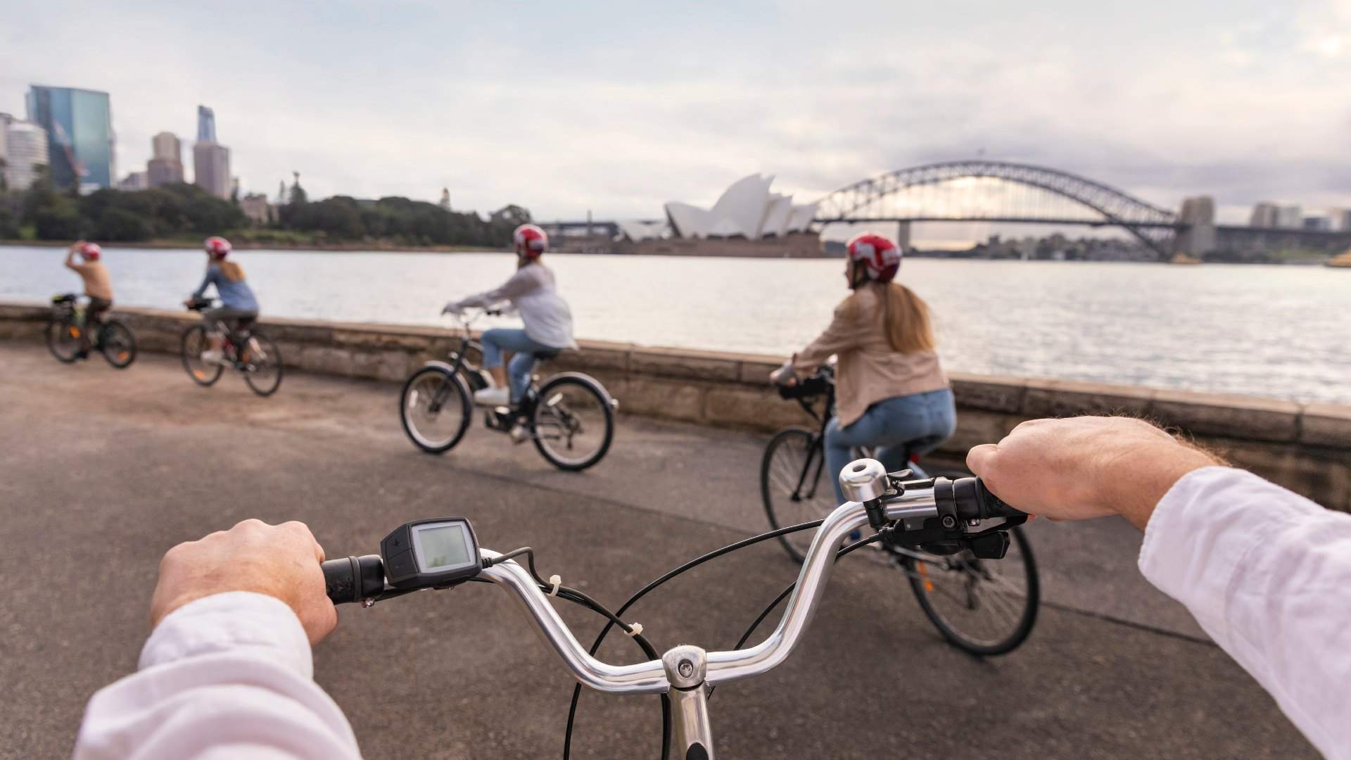 Family enjoying a ride through the Royal Botanic Garden Sydney on their hired bicycles from Bonza Bike Tours