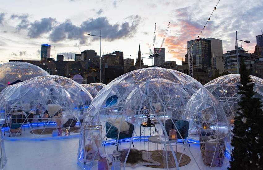 Background image for This Alpine-Inspired Winter Pop-Up Is Touring Its Igloos and Ice Skating Rink Around Australia