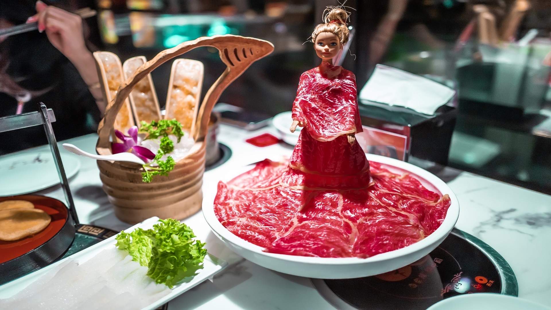 Barbie doll with meat all over her at Spice World - best hot pot in Melbourne