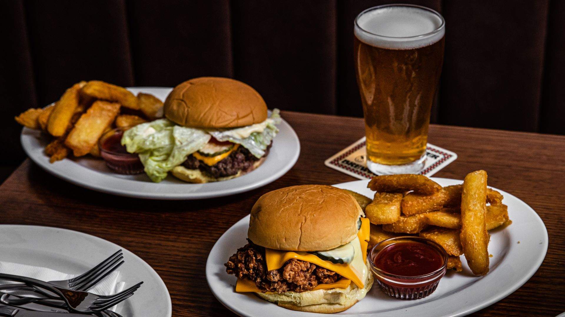 a table at Pub Life Kitchen full of burgers and beer - home to some of the best burgers in Sydney