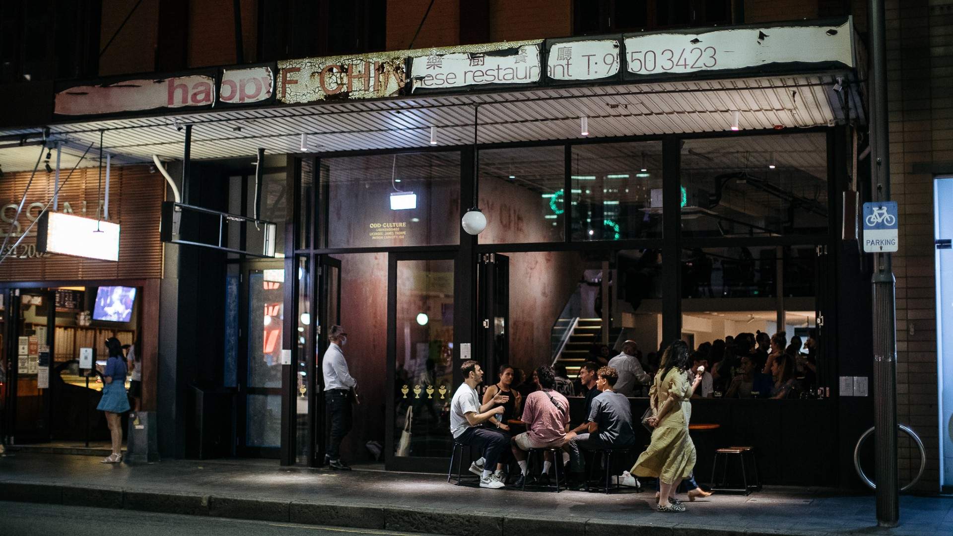 people sitting outside drinking at night at odd culture - one of the best bars in Sydney - newtown