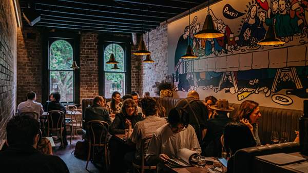 a large group of people drinking and eating in the dining room at Paski Vineria Popolare - one of the best bars in Sydney