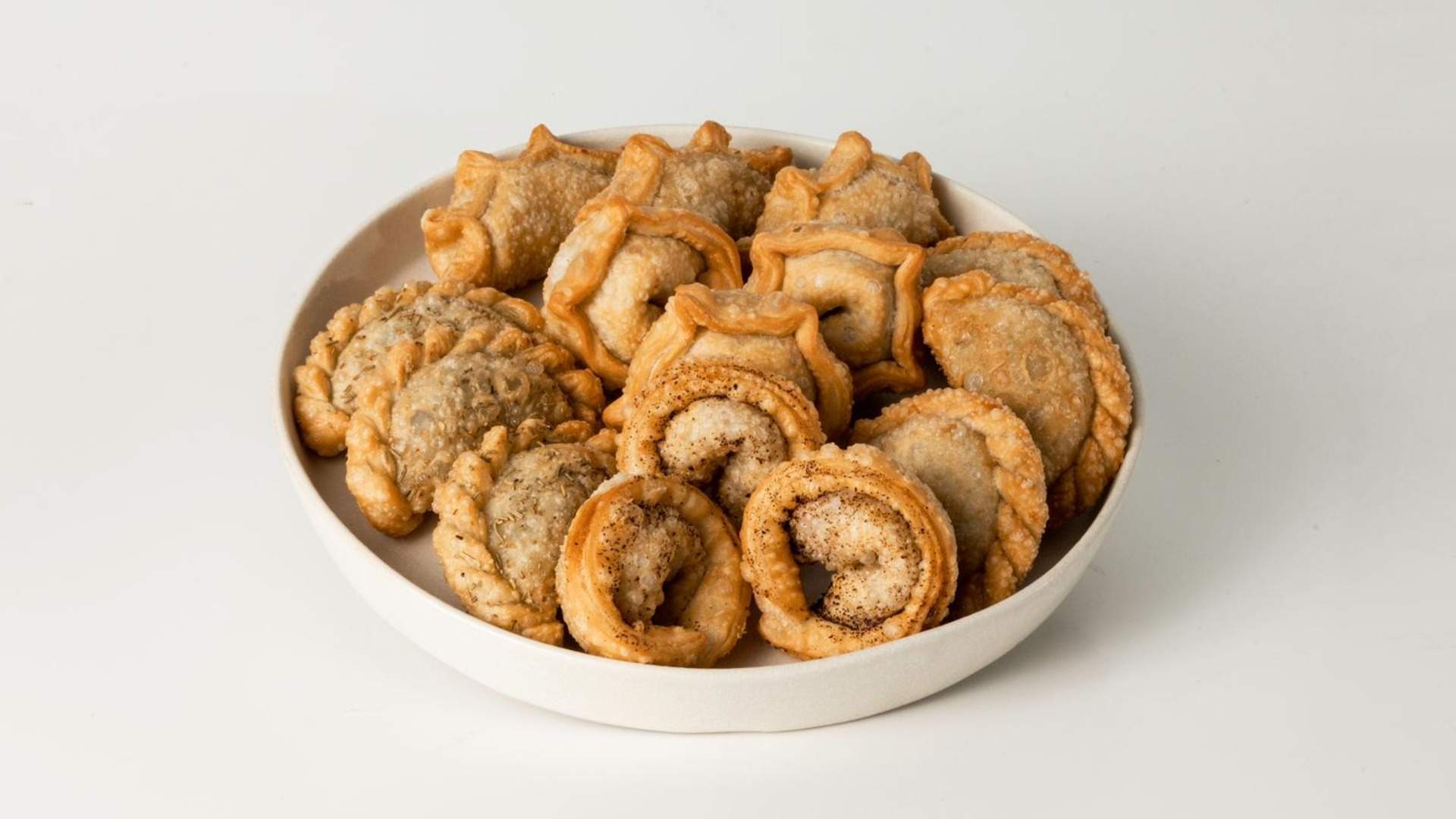 A plate filled with various empanadas