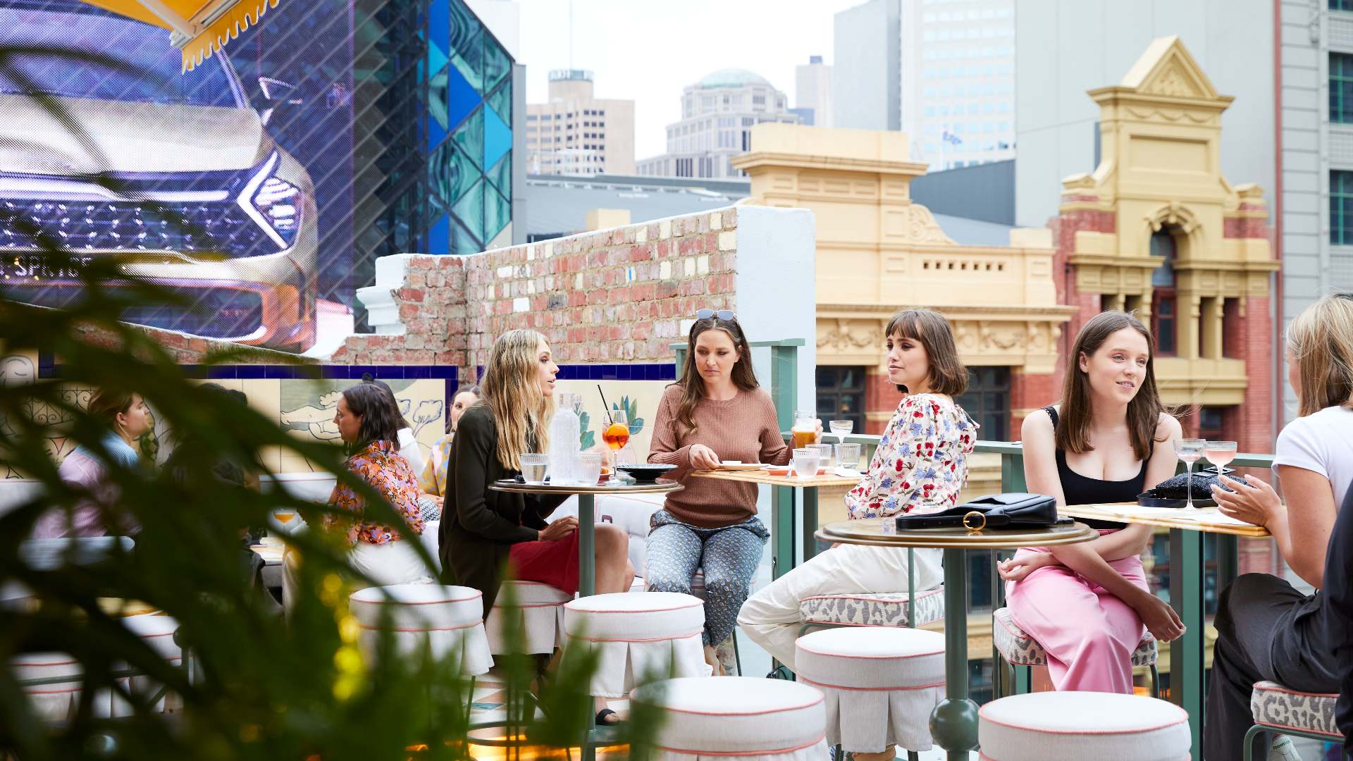 A group of women dining on an openair rooftop