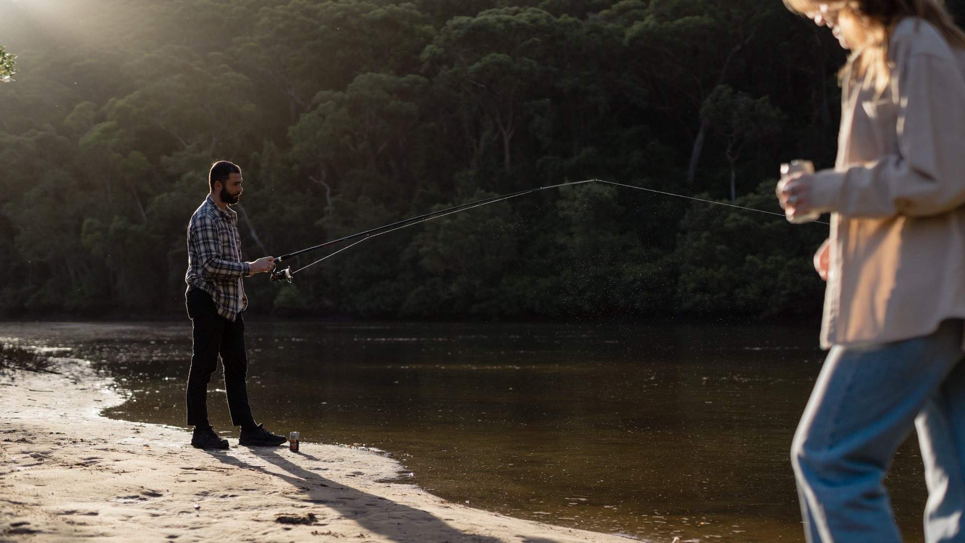 Man fishing on riverbank