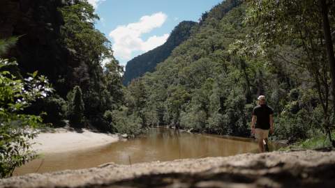 Man walking along riverbank