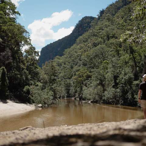 Man walking along riverbank